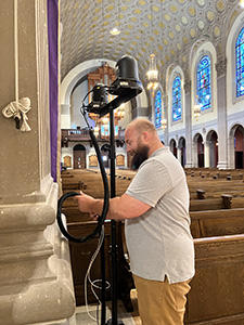 Bearded man setting up PTZ camera