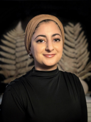 Inaash Islam woman in black with a brown head covering