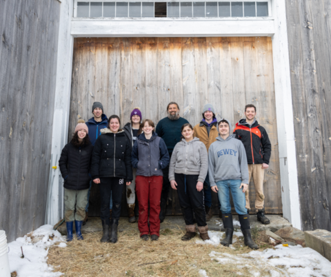 Food, Power, Environment young adults standing in front of a barn